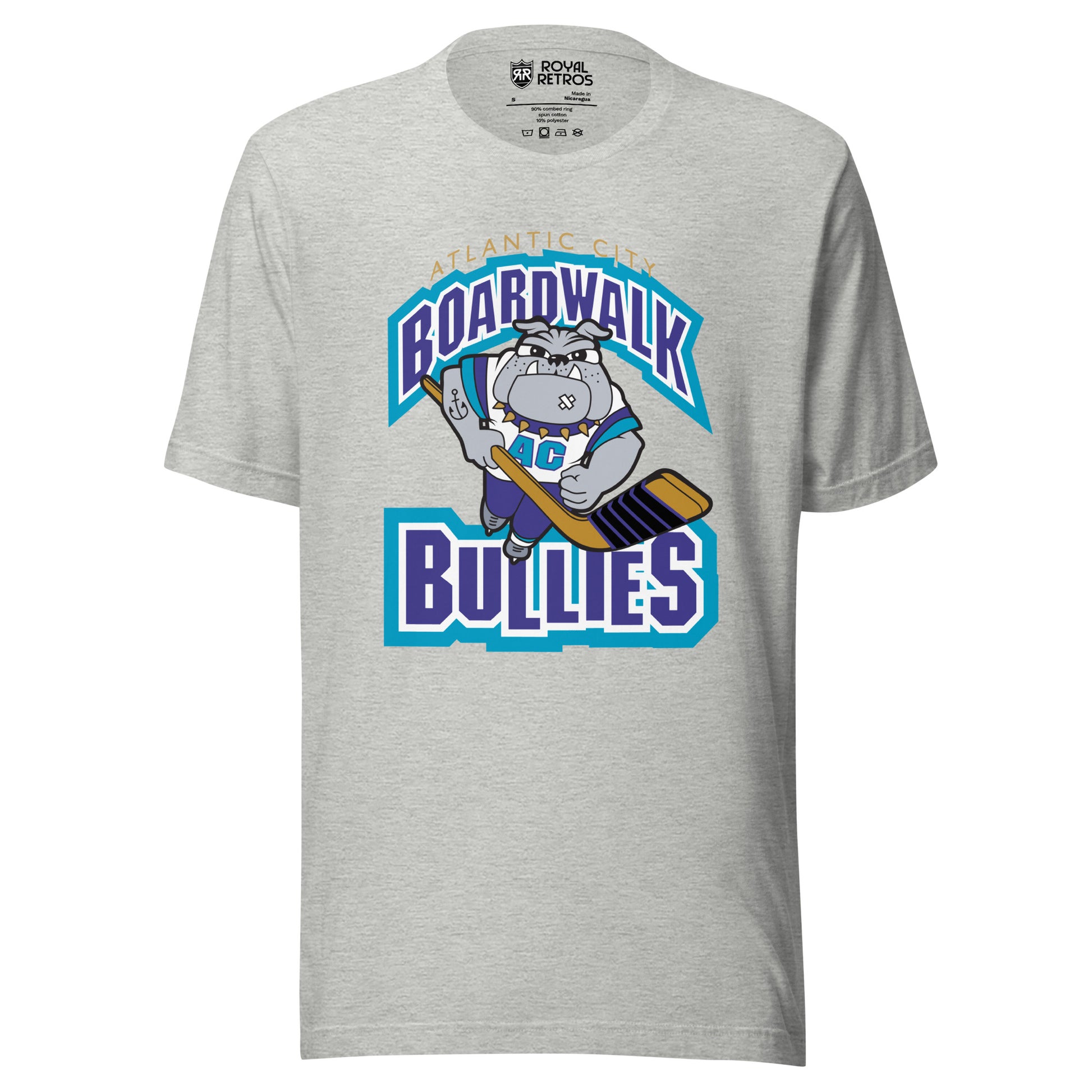 Atlantic City Boardwalk Bullies hockey T-shirt. Gray. Boardwalk arched in purple with white and teal trim. Cartoon bulldog skating toward viewer holding hockey stick. Bullies in purple with white and teal trim. Royal Retros
