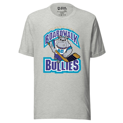Atlantic City Boardwalk Bullies hockey T-shirt. Gray. Boardwalk arched in purple with white and teal trim. Cartoon bulldog skating toward viewer holding hockey stick. Bullies in purple with white and teal trim. Royal Retros
