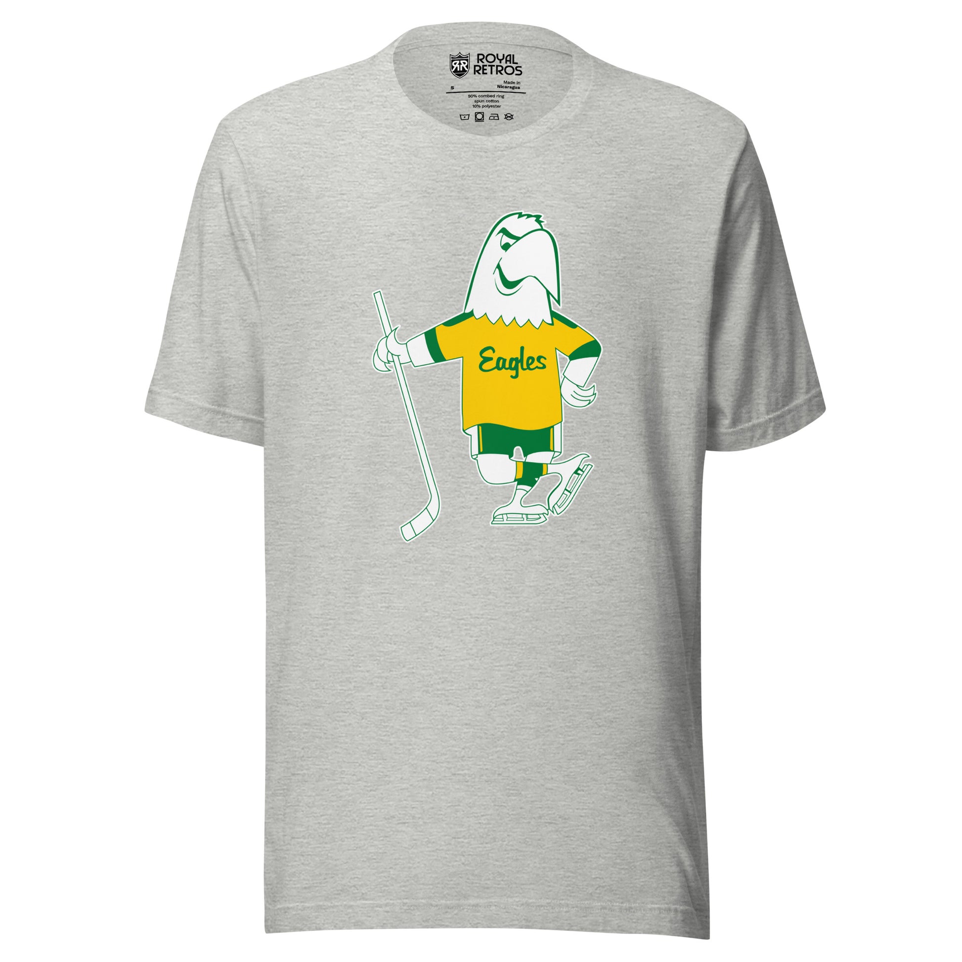 Salt Lake Golden Eagles Hockey T-shirt. Gray. Cartoon white Eagle drawn in green wearing a gold jersey with Eagles in script across chest. Green sleeve ends on Eagle's jersey. Green shorts with yellow stripes. Wearing white skates and holding a hockey stick in his right wing. Royal Retros.