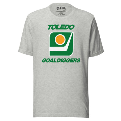 Toledo Goaldiggers hockey T-shirt. Grey. Toledo in green above white outlined square with green background. Inside is a hockey blade with a gold puck with white trim above. Goaldiggers in green below. square. Royal Retros