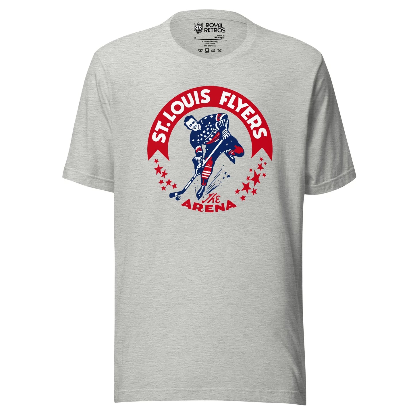 St. Louis Flyers T-shirt. Gray. Red banner arched on chest. St. Louis Flyers in white inside. Player skating toward viewer in red, white, and blue uniform, about to shoot puck. Red stars on either side below ends of banner. "The Arena" in red at bottom of logo. Royal Retros