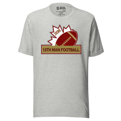 13th Man football T-shirt. Gray. Top of white maple leaf tilted left. Football leaning right. Gold box below with red trim with 13th Man Football in red inside. Royal Retros