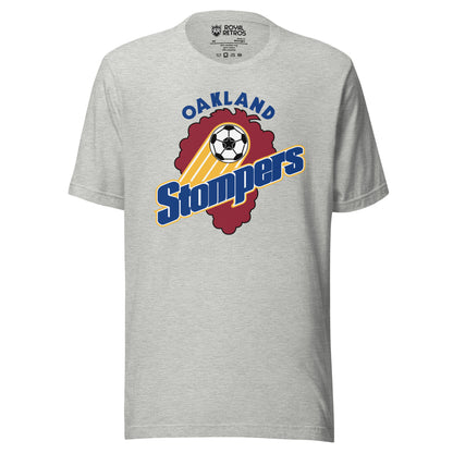 Athletic heather gray t-shirt with an Oakland Stompers graphic: a gold-trailed soccer ball above bold blue 'Stompers' script