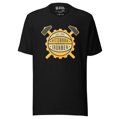 Pittsburgh Ironmen basketball T-shirt. Black. Gold gear with beige and gold basketball pattern in center. Est. 1946 in first band. Pittsburgh with stars on either side in second. Ironmen in next band with stars on either side. Large mallet handles coming out of gear top right and left, handles below bottom left and right. Royal Retros
