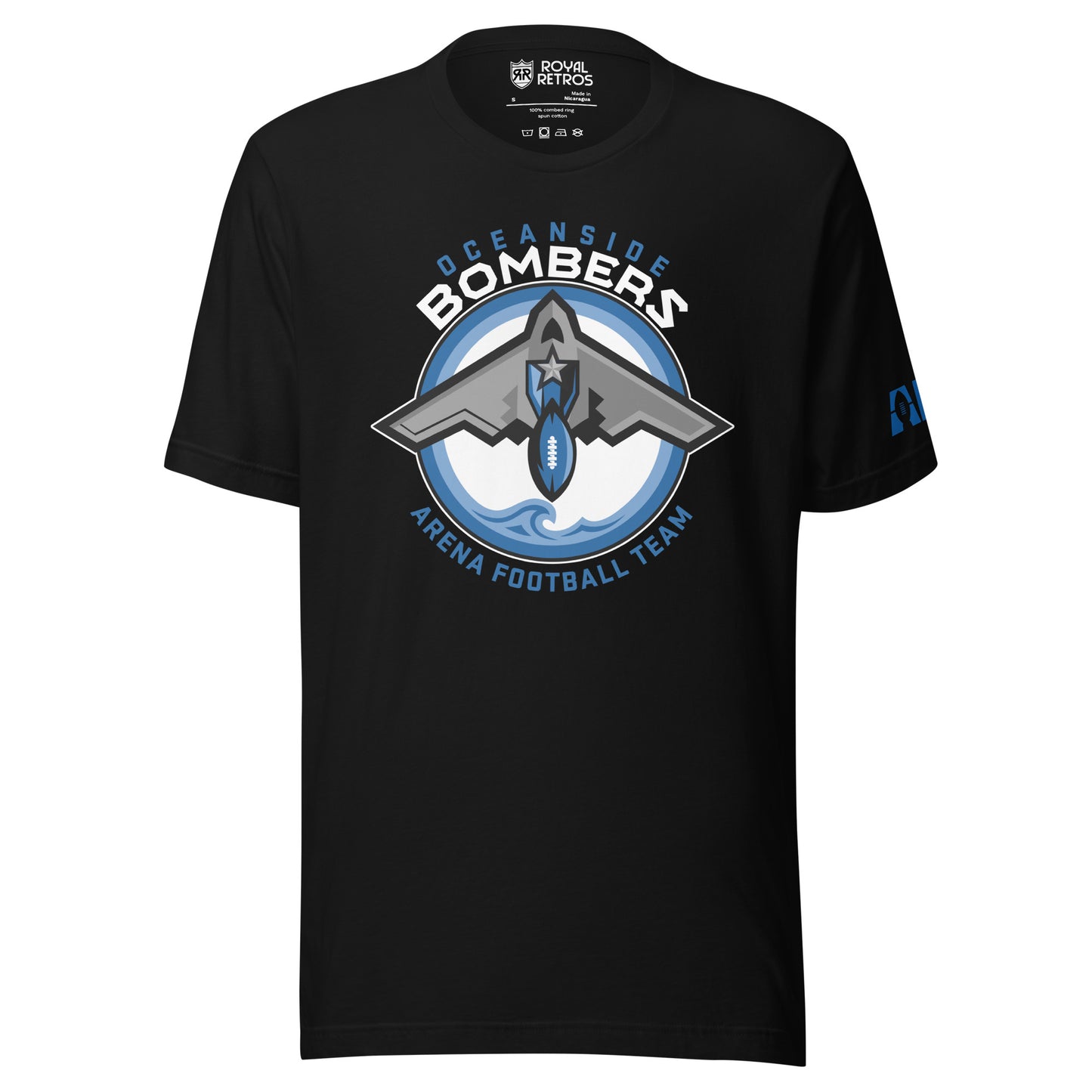 Oceanside Bombers football T-shirt. Black. Oceanside in blue arched above Bombers slightly larger in white over a circle outlined in white and two slightly larger rings, blue and light blue inside. White background. B-2 bomber from the top over the circle with wings slightly protruding. A football coming off the tail. An ocean wave appears in the bottom of the circle. Outside the circle arched below is Arena Football team arched up in blue. Royal Retros