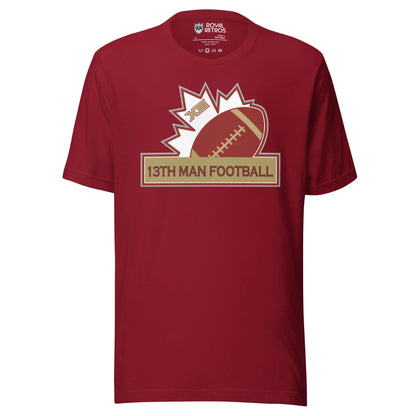 13th Man football T-shirt. Maroon. Top of white maple leaf tilted left. Football leaning right. Gold box below with red trim with 13th Man Football in red inside. Royal Retros