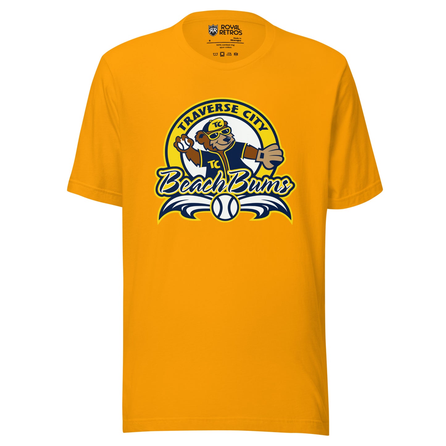 Traverse City Beach Bums baseball T-shirt. Gold. Yellow circle with Traverse City arched inside across top. Inside with bear in blue jersey and yellow cap throwing a baseball. Beach Bums in script across bottom of circle with baseball in middle and decorative wings coming off sides. Royal Retros