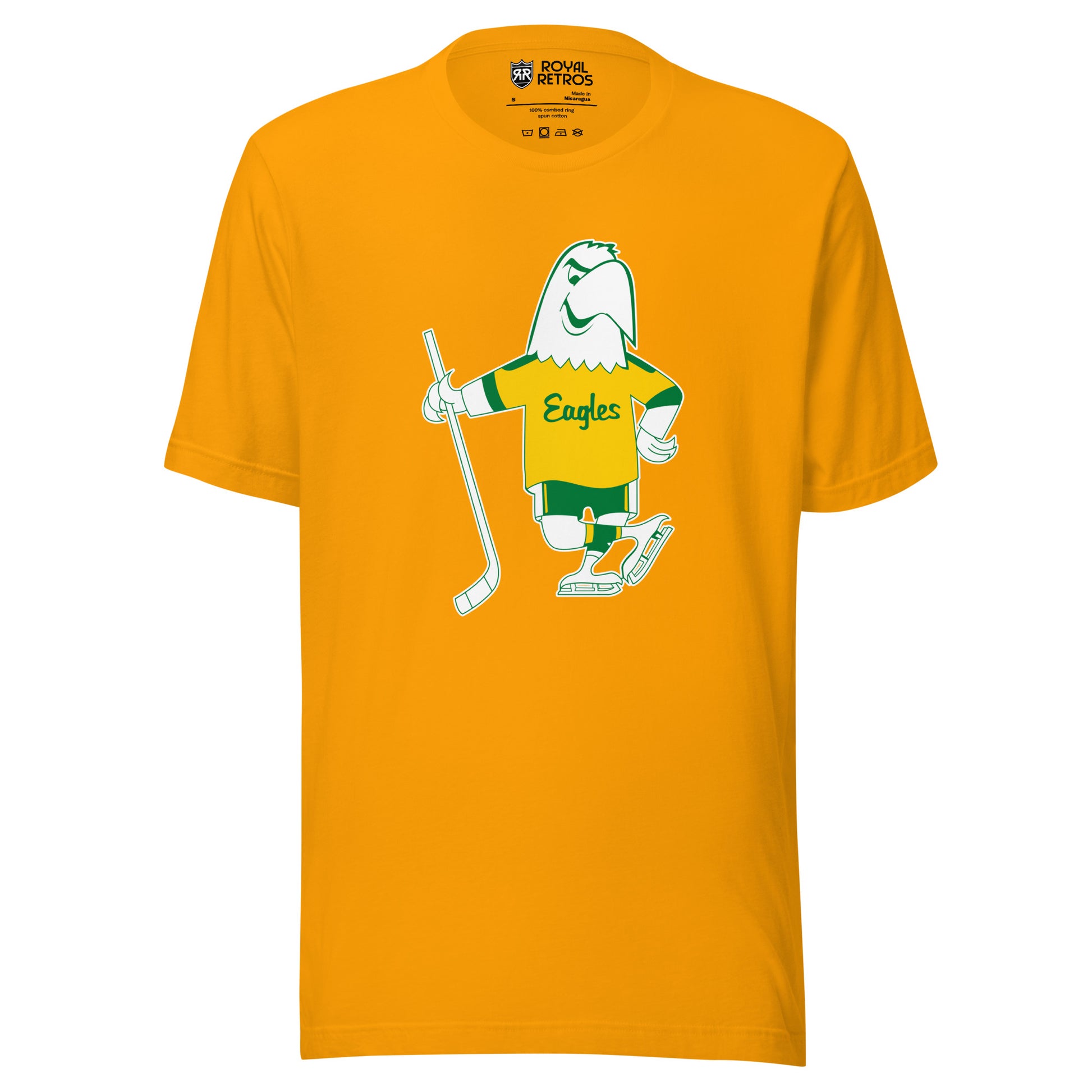 Salt Lake Golden Eagles Hockey T-shirt. Gold. Cartoon white Eagle drawn in green wearing a gold jersey with Eagles in script across chest. Green sleeve ends on Eagle's jersey. Green shorts with yellow stripes. Wearing white skates and holding a hockey stick in his right wing. Royal Retros.