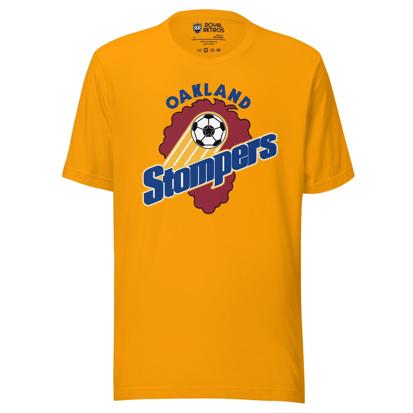 Gold t-shirt with an Oakland Stompers graphic: a gold-trailed soccer ball above bold blue 'Stompers' script