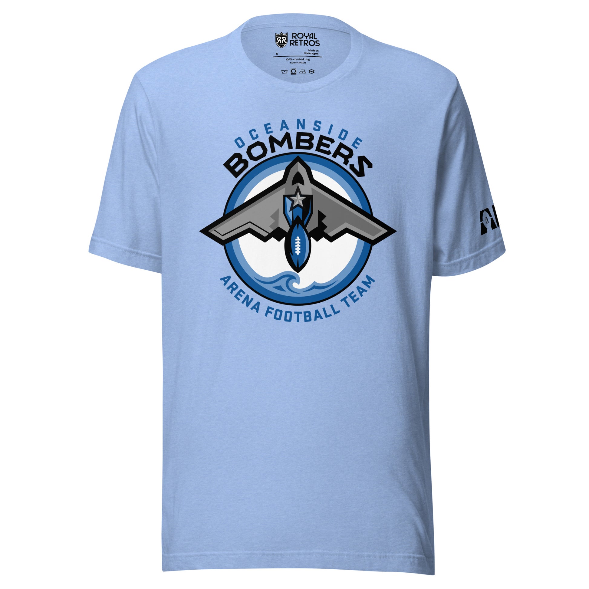 Oceanside Bombers football T-shirt. Carolina Blue. Oceanside in blue arched above Bombers slightly larger in black over a circle outlined in black and two slightly larger rings, blue and light blue inside. White background. B-2 bomber from the top over the circle with wings slightly protruding. A football coming off the tail. An ocean wave appears in the bottom of the circle. Outside the circle arched below is Arena Football team arched up in blue. Royal Retros