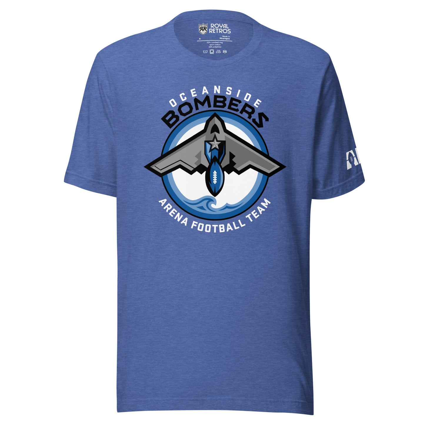 Oceanside Bombers football T-shirt. Royal blue. Oceanside in white arched above Bombers slightly larger in black over a circle outlined in black and two slightly larger rings, blue and light blue inside. White background. B-2 bomber from the top over the circle with wings slightly protruding. A football coming off the tail. An ocean wave appears in the bottom of the circle. Outside the circle arched below is Arena Football team arched up in white. Royal Retros