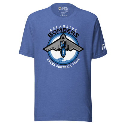 Oceanside Bombers football T-shirt. Royal blue. Oceanside in white arched above Bombers slightly larger in black over a circle outlined in black and two slightly larger rings, blue and light blue inside. White background. B-2 bomber from the top over the circle with wings slightly protruding. A football coming off the tail. An ocean wave appears in the bottom of the circle. Outside the circle arched below is Arena Football team arched up in white. Royal Retros