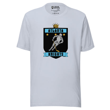 Atlanta Knights hockey T-shirt. Light Blue. Black shield with small gold crown on top. Blue band inside top with ATLANTA in black. 3 gold stars below that. Knight with hockey stick skating leaning right. Blue banner with Knights below bottom if shield. Royal Retros. 