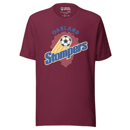 Maroon t-shirt with an Oakland Stompers graphic: a gold-trailed soccer ball above bold blue 'Stompers' script