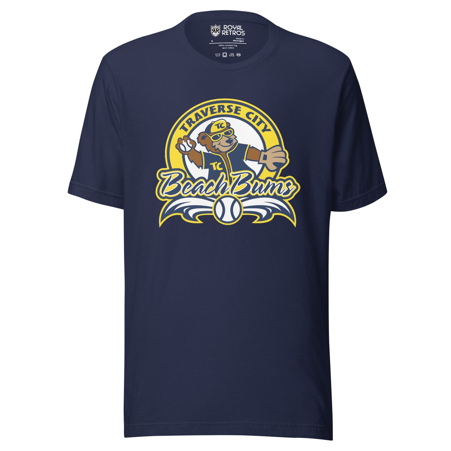 Traverse City Beach Bums baseball T-shirt. Navy. Yellow circle with Traverse City arched inside across top. Inside with bear in blue jersey and yellow cap throwing a baseball. Beach Bums in script across bottom of circle with baseball in middle and decorative wings coming off sides. Royal Retros