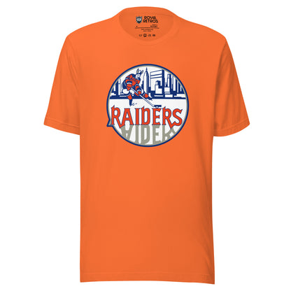 New York Raiders WHA T-shirt. Orange. Logo on chest. White circle, with hockey player skating in front of Manhattan Skyline in blue. Raiders in orange below skater, reflected in gray below. Royal Retros