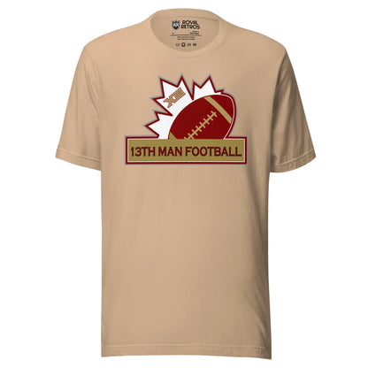 13th Man football T-shirt. Tan. Top of white maple leaf tilted left. Football leaning right. Gold box below with red trim with 13th Man Football in red inside. Royal Retros