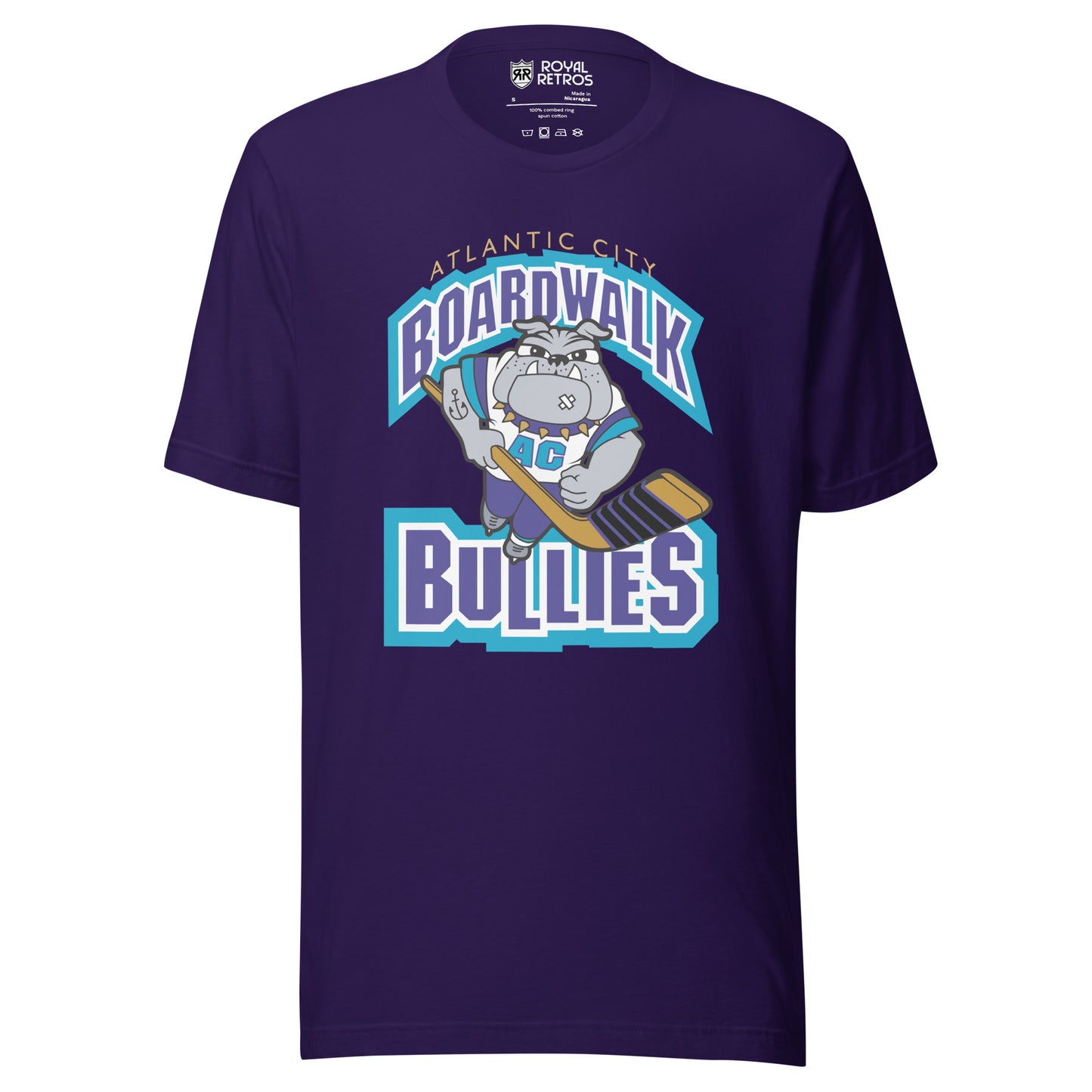 Atlantic City Boardwalk Bullies hockey T-shirt. Purple. Boardwalk arched in purple with white and teal trim. Cartoon bulldog skating toward viewer holding hockey stick. Bullies in purple with white and teal trim. Royal Retros