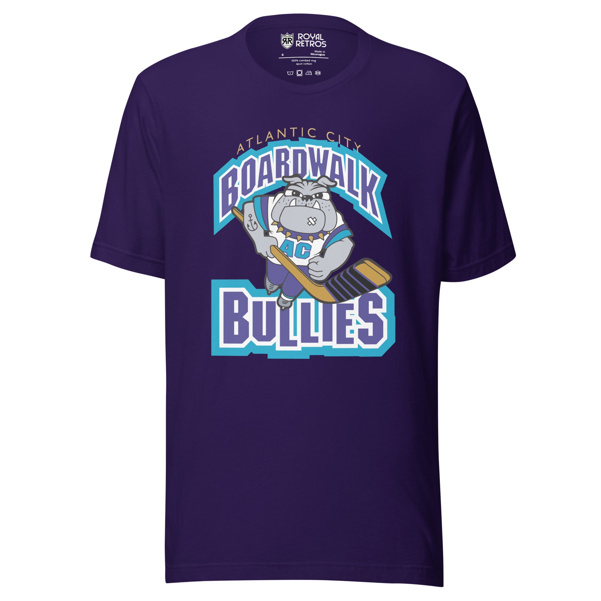 Atlantic City Boardwalk Bullies hockey T-shirt. Purple. Boardwalk arched in purple with white and teal trim. Cartoon bulldog skating toward viewer holding hockey stick. Bullies in purple with white and teal trim. Royal Retros