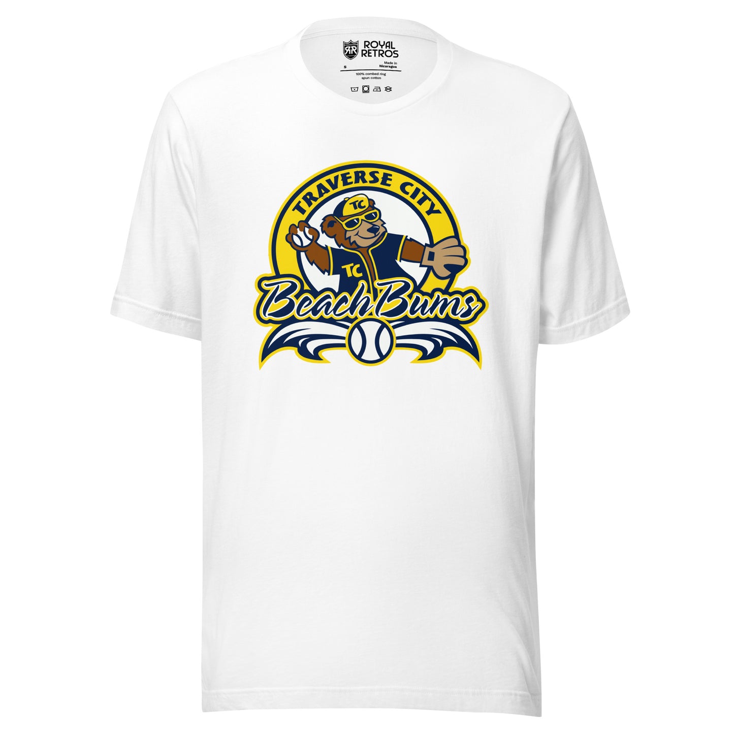 Traverse City Beach Bums baseball T-shirt. White. Yellow circle with Traverse City arched inside across top. Inside with bear in blue jersey and yellow cap throwing a baseball. Beach Bums in script across bottom of circle with baseball in middle and decorative wings coming off sides. Royal Retros