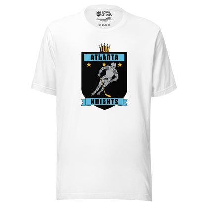 Atlanta Knights hockey T-shirt. White. Black shield with small gold crown on top. Blue band inside top with ATLANTA in black. 3 gold stars below that. Knight with hockey stick skating leaning right. Blue banner with Knights below bottom if shield. Royal Retros. 