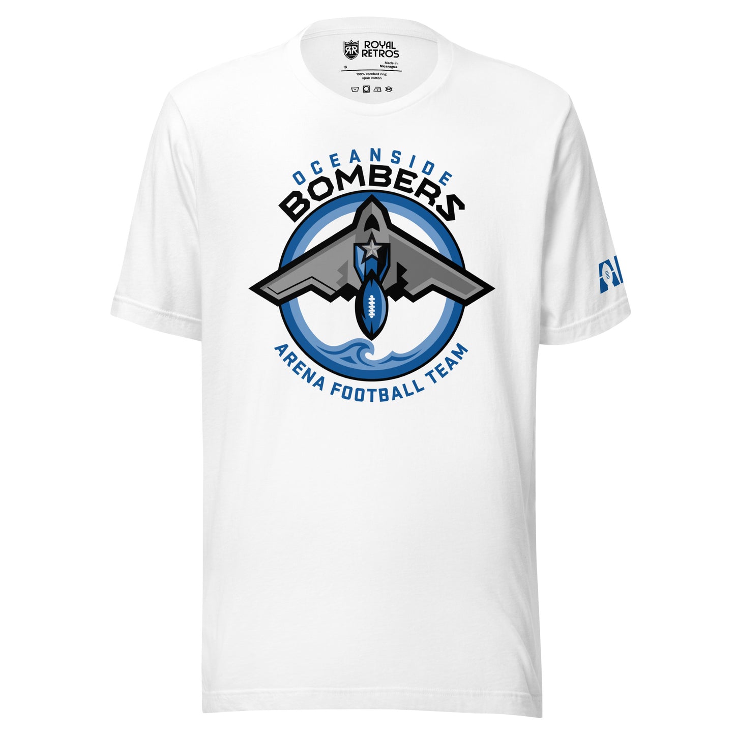 Oceanside Bombers football T-shirt. White. Oceanside in blue arched above Bombers slightly larger in black over a circle outlined in white and two slightly larger rings, blue and light blue inside. White background. B-2 bomber from the top over the circle with wings slightly protruding. A football coming off the tail. An ocean wave appears in the bottom of the circle. Outside the circle arched below is Arena Football team arched up in blue. Royal Retros