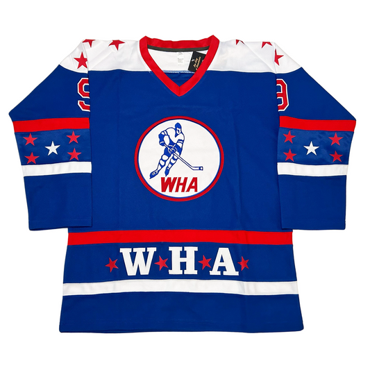 WHA All-Star Jersey. Blue. Red collar. White shoulder with red stars. Red band mid-sleeve, 4 red stars and one white star, white band below. Red band around waist. WHA in white with red stars before, after and between letters. White banc below. WHA logo. Red circle, white background, blue skater, WHA in red at bottom of circle. Royal Retros