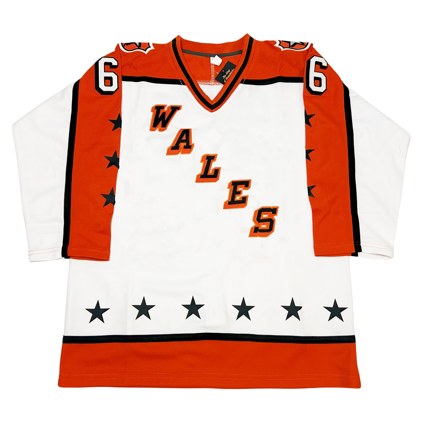 Prince of Wales Conference All-Star Hockey Jersey. White. Orange shoulders and half orange sleeves with black trim. 3 black stars on orange part of sleeves. WALES diagonal left down to right, black letters with orange trim. Thin black and wide orange band at waist. Orange, black, and orange collar. 6 stars above bands on waist. #66 in white with black trim on sleeves. Royal Retros.