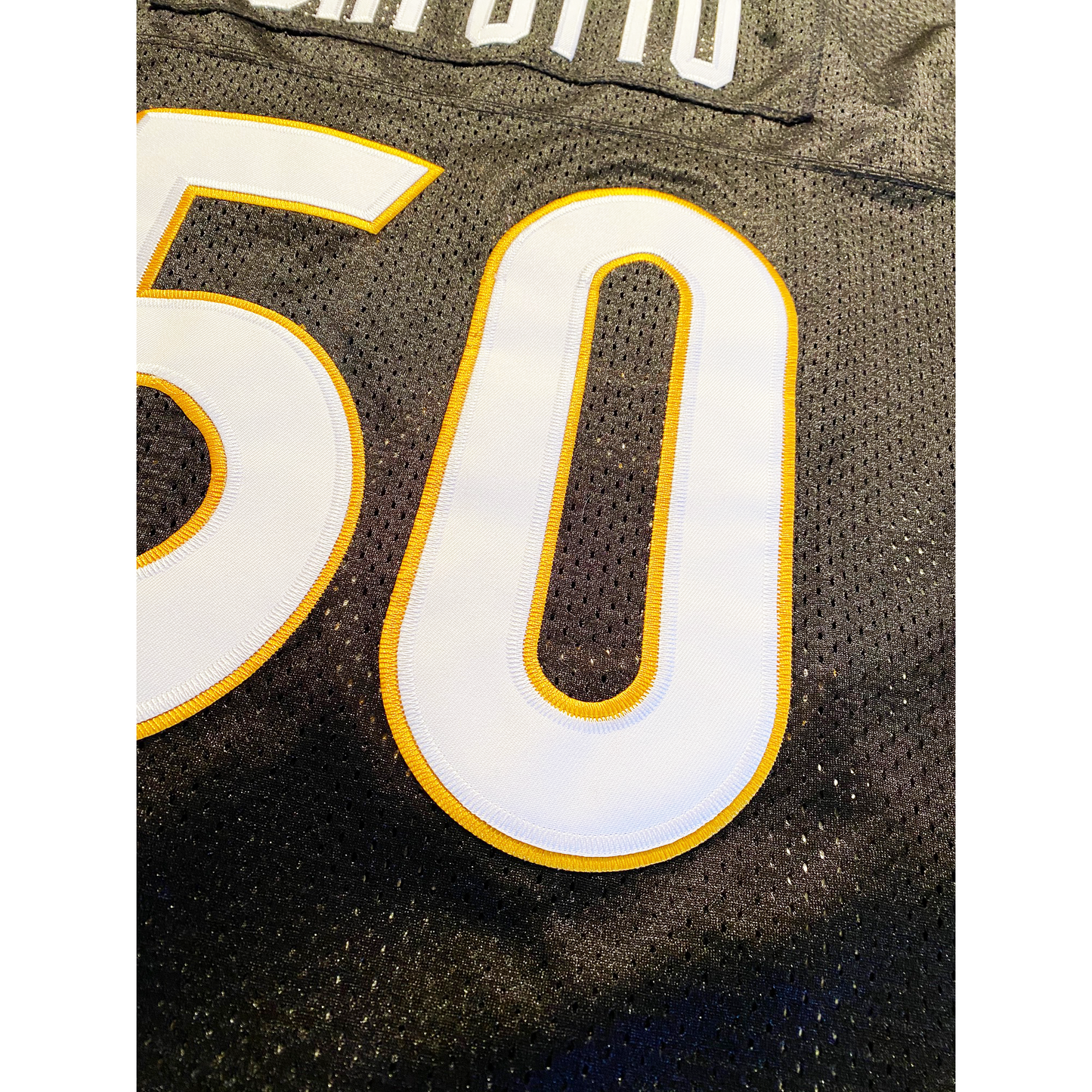 Oakland Senors Football Jersey black. Close-up of #50, White numerals with gold trim. Royal Retros
