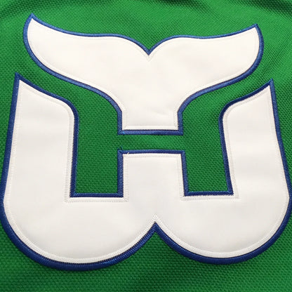 1980s Hartford Whalers green jersey whale-tail W crest close-up — Royal Retros