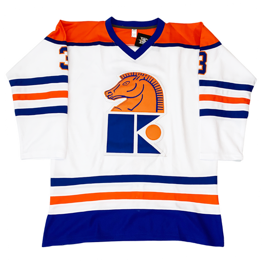 Jersey Knights hockey jersey white. Orange shoulders with blue trim and blue collar. Blue, white, orange, white, and blue bands mid-sleeve and around waist. Horses head in orange with blue detail looking left  over K with orange circle to the right. Royal Retro