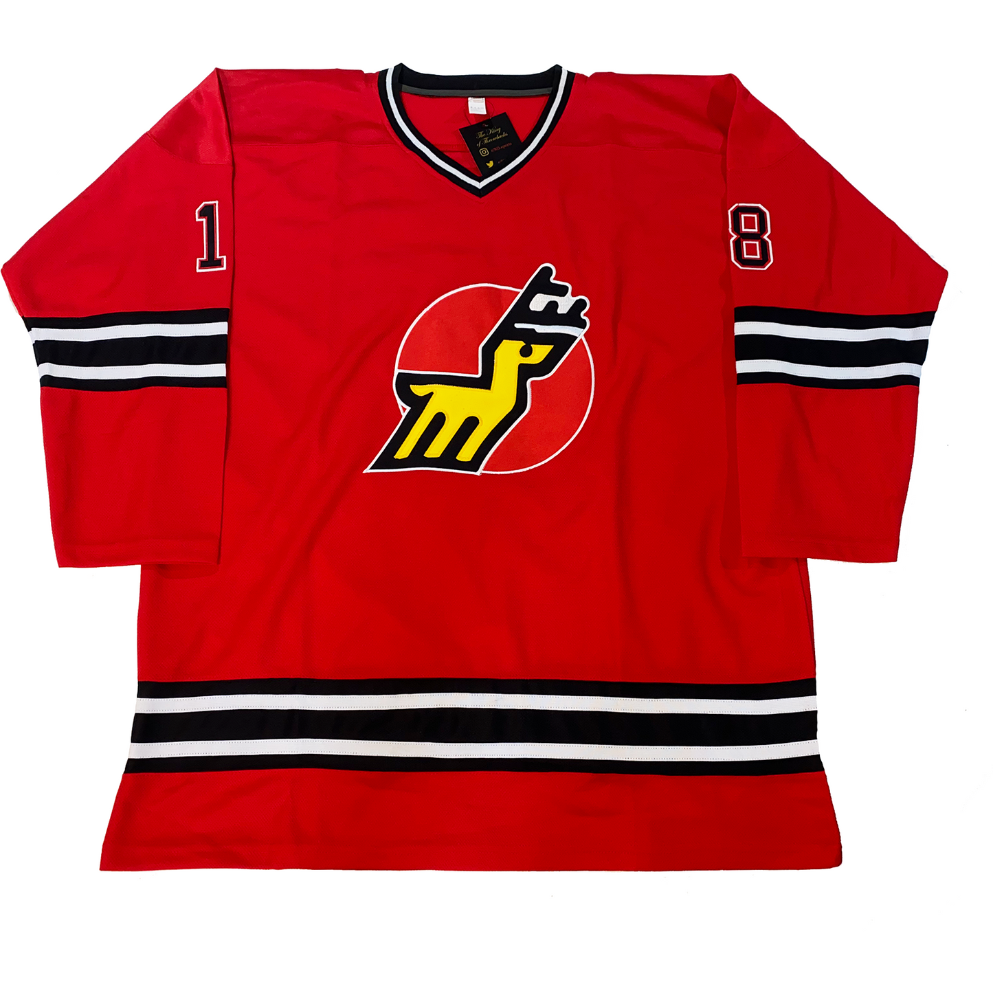 Michigan Stags Jersey red, Black, white, and black collar. Black, white, black, white, black bands mid-sleeve and just above waist. #18 in black with white trim small on shoulders. Red circle on chest with stylized gold deer with black antlers. Royal Retros