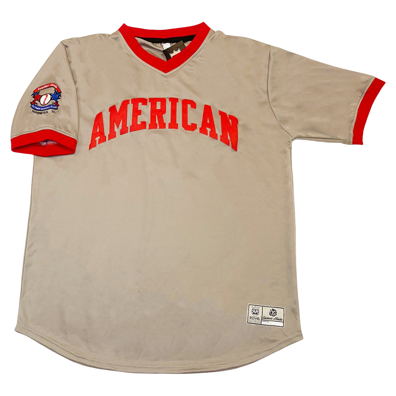 Old Timers Game American League baseball jersey. Gray. AMERICAN in red block letters arched across chest. Red sleeve ends and collar. Royal Retros