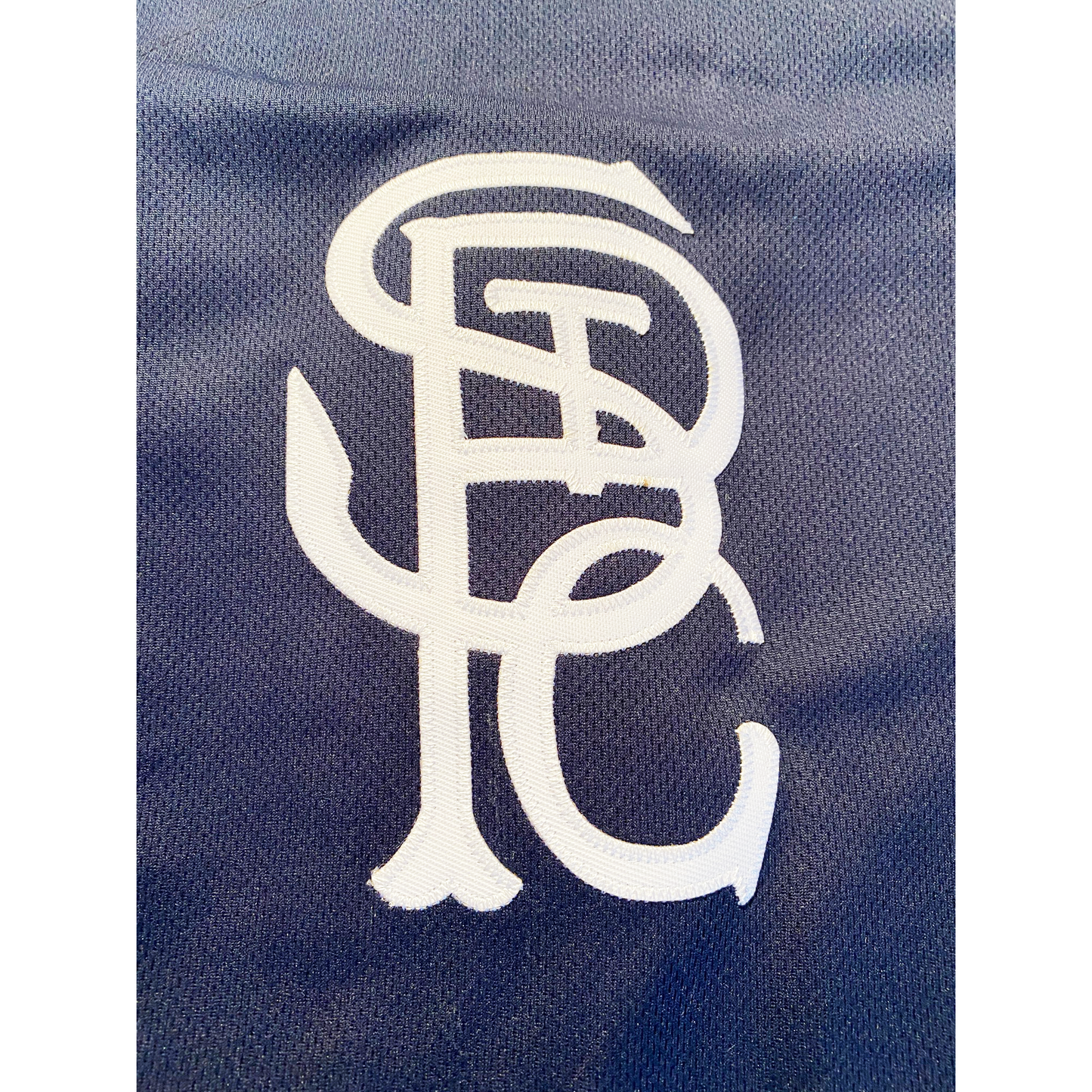 St Paul Gophers jersey blue. Close-up of white interlocking white STPG